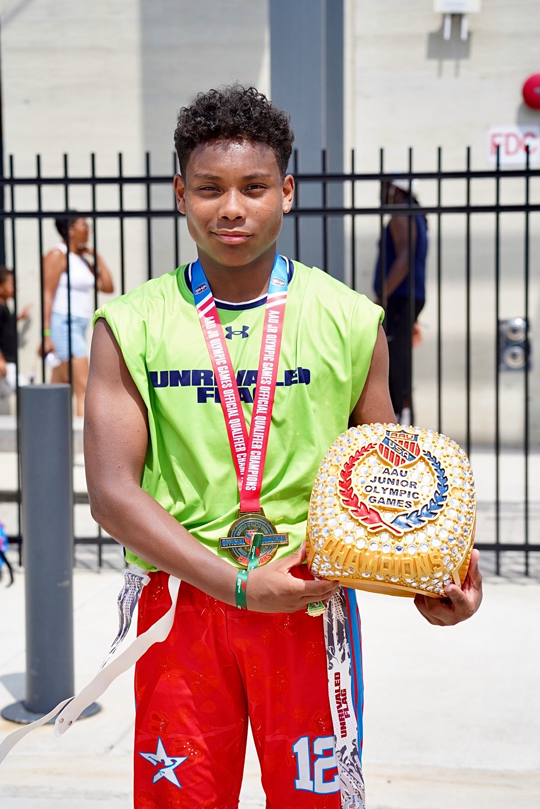 Alexander Jones-Cruz holding his AAU Junior Olympic Games championship award